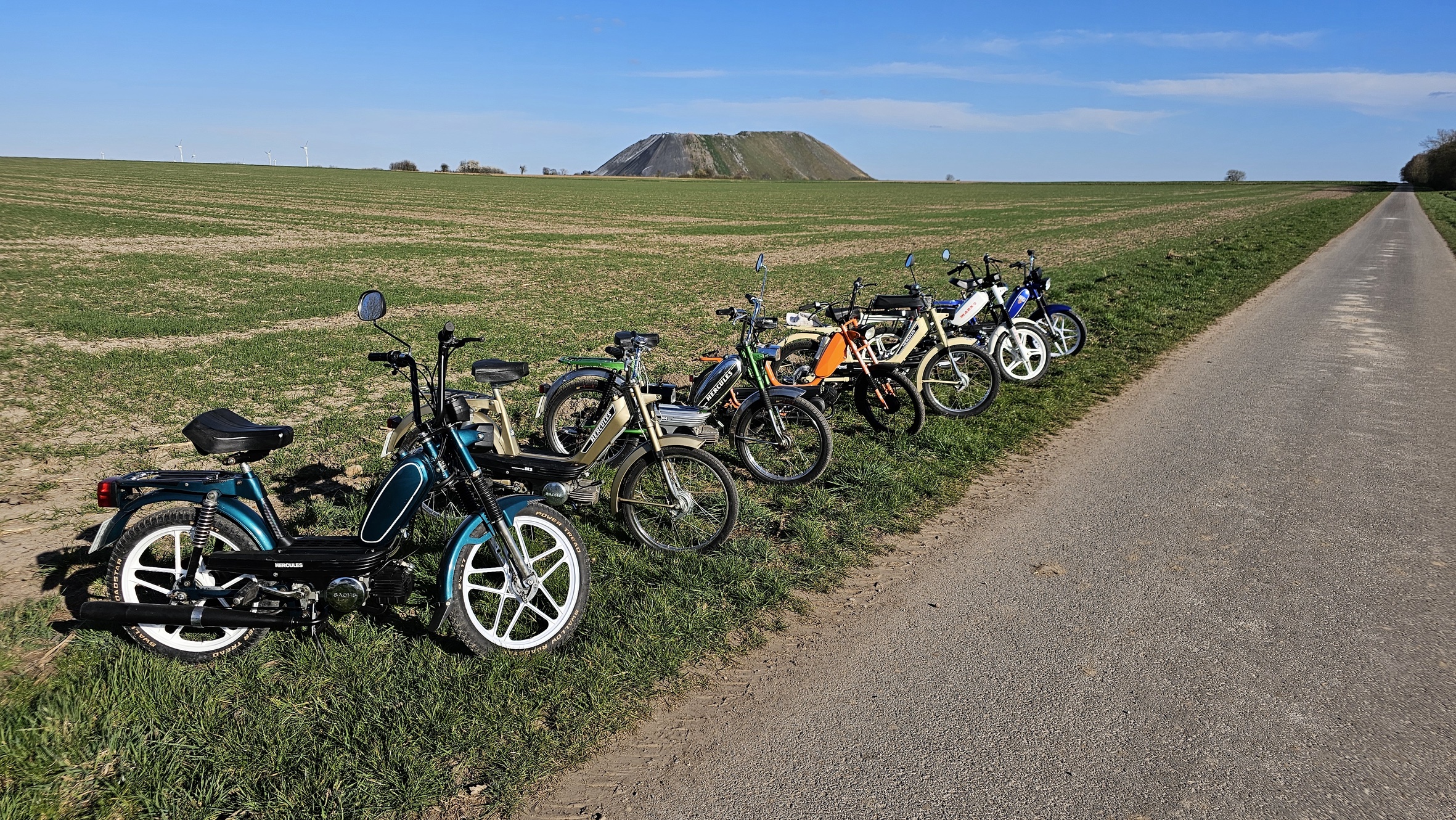 Mofas in Reihe vor Kaliberg im Feld